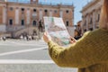 Blonde Woman with paper map is walking on a sunny day. Piazza del Campidoglio on Capitoline Hill, Rome, Italy. Concept Royalty Free Stock Photo