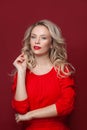 Blonde woman with perfect makeup. Beautiful model woman with curly hairstyle. Care and beauty, lady in red dress Royalty Free Stock Photo