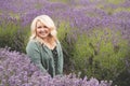 Blonde woman poses in a field of lavender at a farm in Sequim Washington during the lavender festival summer season, looking Royalty Free Stock Photo
