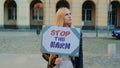 Blonde woman protesting to stop harm by holding steamer