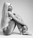 Blonde woman in ragged jeans and vest Royalty Free Stock Photo