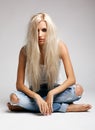 Blonde woman in ragged jeans and vest Royalty Free Stock Photo