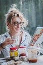 Blonde woman reading a magazine at breakfast time. Royalty Free Stock Photo