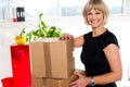 Blonde woman is ready to unpack her office stuff Royalty Free Stock Photo