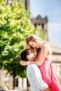 Blonde woman in red dress having fun with her man. A man holding a woman in his arms. Love story Royalty Free Stock Photo