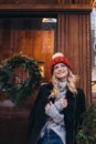 Blonde woman in red knitted hat