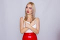Blonde woman in red leather skirt and white shirt