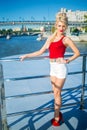 Blonde woman in red top on back of ship near Royalty Free Stock Photo