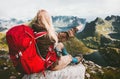 Blonde woman relaxing alone with red backpack in mountains Royalty Free Stock Photo