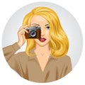 Blonde woman with retro photo camera in her hand Royalty Free Stock Photo