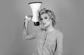 Blonde woman in retro style shouting through a megaphone. Idea for marketing or sales banner. Royalty Free Stock Photo