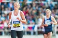 Blonde woman running the final stretch at Stockholm Stadion