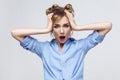 Blonde woman screaming with shock, holding hands on her head. Royalty Free Stock Photo