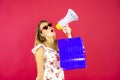 Blonde woman shouting with a megaphone in studio Royalty Free Stock Photo