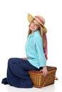Blonde woman sitting on picnic basket Royalty Free Stock Photo