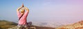 Blonde woman sitting in yoga pose on top of a mountain, meditation and solitude in nature, copy space