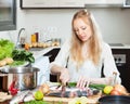 Blonde woman slicing raw fish Royalty Free Stock Photo