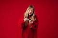 Blonde woman smiling while playing game on cellphone Royalty Free Stock Photo