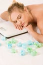 Blonde woman in spa dreaming on weight scales Royalty Free Stock Photo