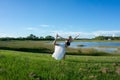 blonde woman spiritual doing yoga king dance standing pulling bow Natarajasana / Dandayamana Dhanurasana pose in nature Royalty Free Stock Photo