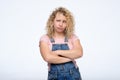 Blonde woman standing with arms folded and looking away