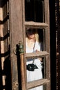 Blonde woman stands in the old wooden doorway. The old wooden door. Young woman modern portrait Royalty Free Stock Photo