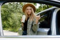 Blonde woman stoped on road next to car and drink coffee or tea from reusable mug. Refuse reuse recycle zero waste