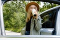 Blonde woman stoped on road next to car and drink coffee or tea from reusable mug. Refuse reuse recycle zero waste