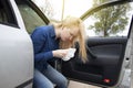 Nausea during a car trip. A blonde woman suffers from kinetosis. The concept of motion sickness in diseases of the transport and Royalty Free Stock Photo