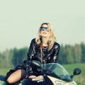 Blonde woman in sunglasses on a sports motorcycle Royalty Free Stock Photo