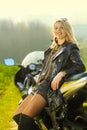 Blonde woman in sunglasses on a sports motorcycle Royalty Free Stock Photo