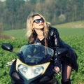 Blonde woman in sunglasses on a sports motorcycle Royalty Free Stock Photo