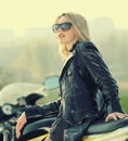 Blonde woman in sunglasses on a sports motorcycle Royalty Free Stock Photo