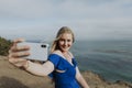 Blonde woman taking photos with her phone Royalty Free Stock Photo