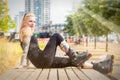 Blonde woman with tattoos and roller blades relaxing