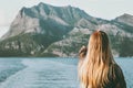 Blonde Woman traveling by ferry enjoying Norway mountains and sea landscape Travel Lifestyle concept adventure vacations Royalty Free Stock Photo