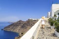 Blonde woman walking street of Thira in Santorini, Greece Royalty Free Stock Photo