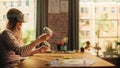 Blonde Woman Wearing 3D VR Headset And Using Modern Controllers in Loft Apartment. Female Designer