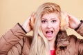 Blonde woman in winter earmuffs and jacket