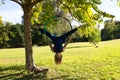 Blonde woman and young gymnast acrobat athlete performing aerial exercise on air ring outdoors in park. Lithe woman in blue