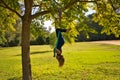 Blonde woman and young gymnast acrobat athlete performing aerial exercise on air ring outdoors in park. Lithe woman in blue