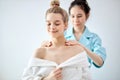 Cute woman doing relaxing neck massage in salon. Classic massage for purpose prevention.