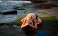 Blonde yogi practicing Lotus pose with back bend. Hands in namaste mudra. Self care concept. Yoga retreat. Tanah Lot beach, Bali