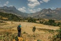 Blonde young girl hiking in Laotian mountains. Beautiful view of Laos landscape, spring valley, rice fields and Asian