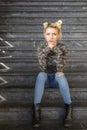 Serious blonde girl sitting on stairs Royalty Free Stock Photo