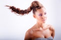 blonde young girl in whimsical coiffure hanging in air