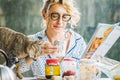 Blonde woman with a cat at breakfast time. Royalty Free Stock Photo