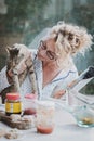 Blonde woman with a cat at breakfast time. Royalty Free Stock Photo