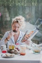 Blonde woman earring a toast at breakfast time. Royalty Free Stock Photo