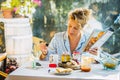 Blonde woman preparing a drink at breakfast time. Royalty Free Stock Photo